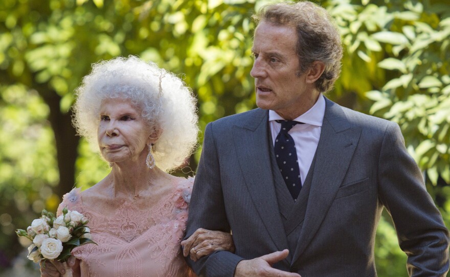 Maria del Rosario Cayetana Fitz-James Stuart, the duchess of Alba, and her husband, Alfonso Diez, walk out of the chapel after their wedding at Las Duenas Palace in Seville, on Oct. 5, 2011. The duchess of Alba died Thursday. She was 88.