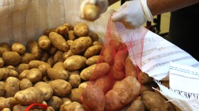 Volunteers prepare potatoes for distribution at Feeding San Diego's headquarters on Thursday, April 3, 2025.