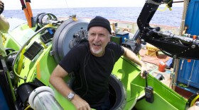 James Cameron emerging from the Deepsea Challenger, the one-man submarine he piloted nearly seven miles below the surface of the Pacific Ocean. 