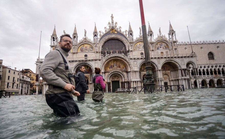 Tourists walk across flooded St. Mark's Square two days after Venice suffered its highest tide in 50 years.