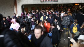 Crowds of people stream out of the Capitol South metro station January 19, 2009 in Washington, DC.