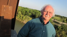 John Wood, a Texas businessman, stands at the edge of an unfinished rail bridge that will link Brownsville, Tex., with Mexico. He's closely watching the Mexican presidential election. 