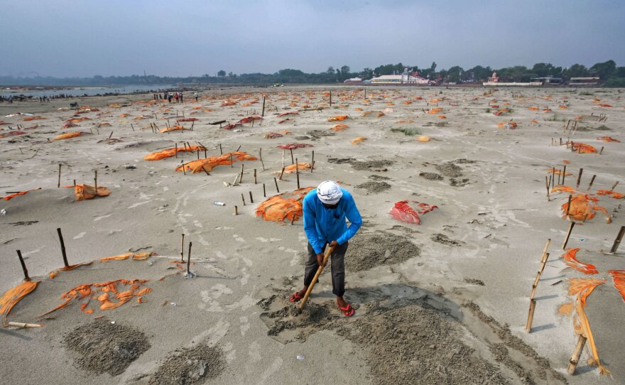 Rains have washed away the top layer of sand of shallow graves at a cremation ground on the banks of the Ganges River in Shringverpur, northwest of Allahabad, Uttar Pradesh, India. Coronavirus testing is limited in parts of rural India, but some of the people buried there are believed to have died of COVID-19.