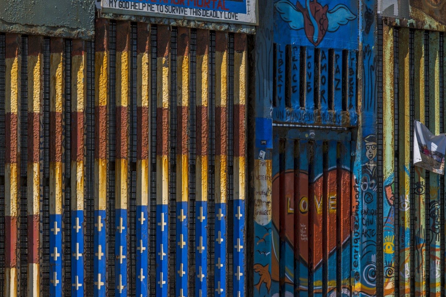 View of the border wall separating Tijuana from San Diego. The murals have been painted by artists from all over the world. The upside-down American flag was made in memory of deported veterans, whose names make up the painted stripes, Tijuana Aug. 18, 2023.