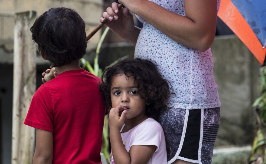 Three-year-old Deyanery Ramirez is in the La Perla neighborhood of San Juan, Puerto Rico, on Thursday. Without cell service on the island, it has been difficult for people to check on their loved ones.