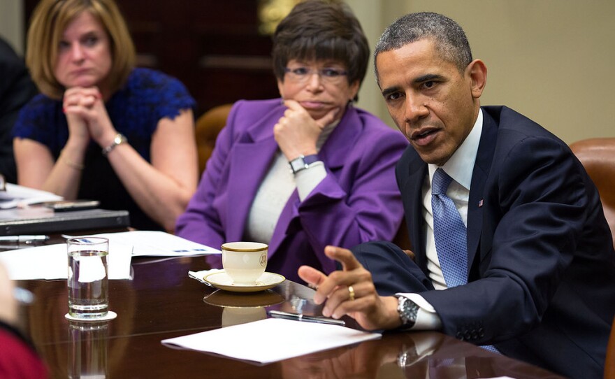 President Barack Obama meets with advisors in the Roosevelt Room of the White House, Dec. 18, 2013. Seated next to the President are Communications Director Jennifer Palmieri, left, and Senior Advisor Valerie Jarrett.