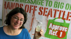 Heather Trim, a volunteer for the Seattle Green Bag Campaign, carries around a sample of polluted Pacific Ocean water.  She says the ocean's "great garbage patch" of non-biodegradable plastic fragments is the reason for her opposition to disposable plastic bags.