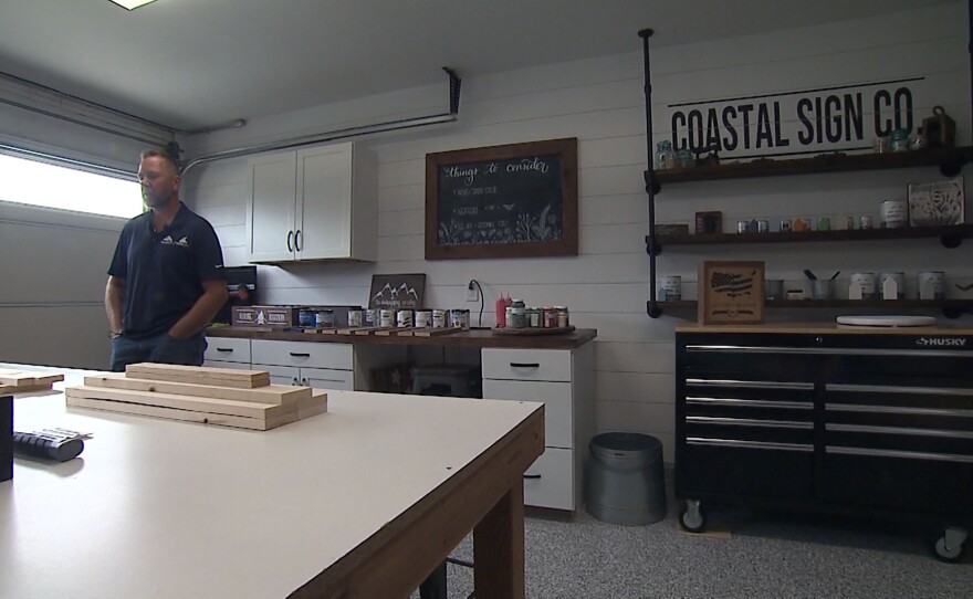 Mike Andela, former Marine, stands in his business, Coastal Sign Company, in Oceanside. April 23, 2021.
