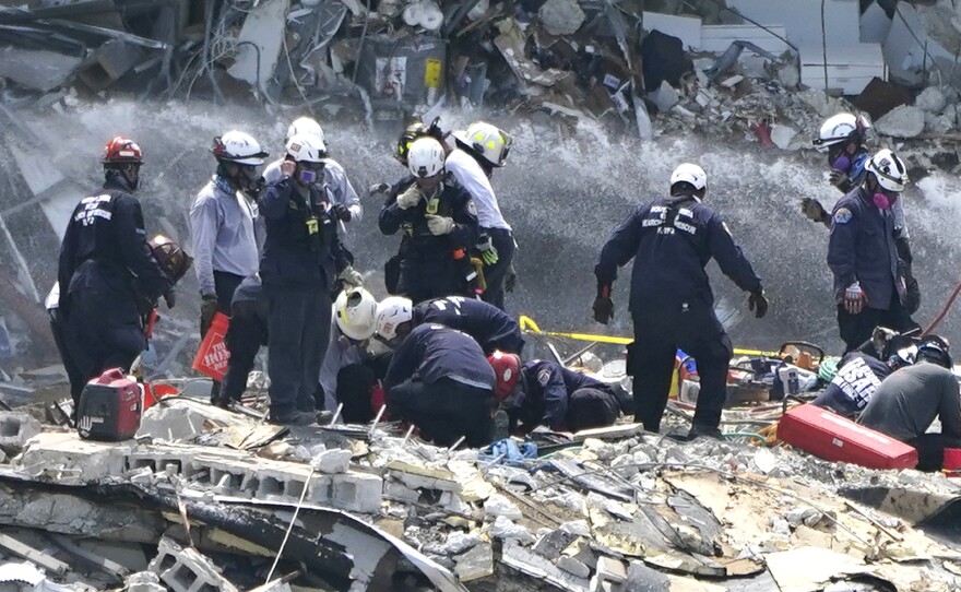 Rescue workers search the rubble of the Champlain Towers South condominium, Saturday. Search and rescue teams found another victim buried underneath the rubble on Tuesday, bringing the death toll to 12.