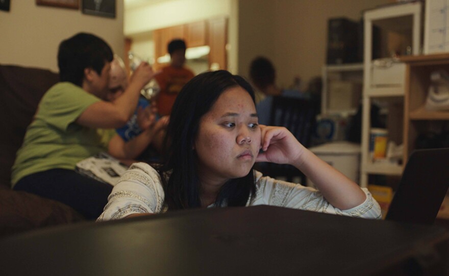 Cathy, a student from T.M. Landry College Prep, waits for an important email.