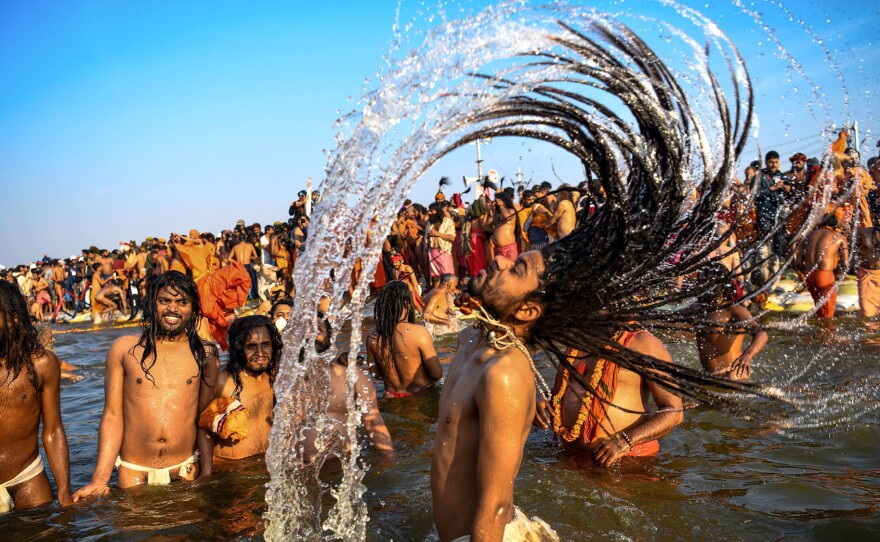 Hindu holy men sample the sacred waters, which are believed to be restorative, with the power to cleanse sin.