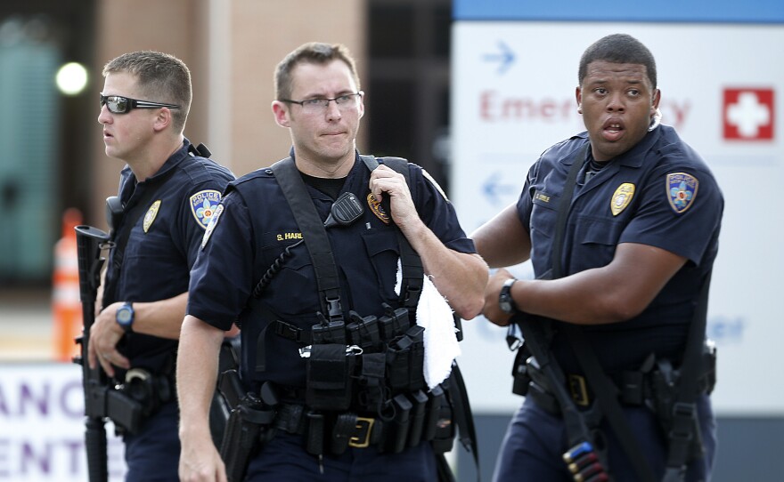 Police guard the emergency room entrance of Our Lady Of The Lake Medical Center, where wounded officers were brought on Sunday in Baton Rouge, La.