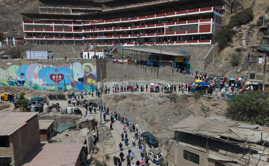 Voters line up outside a polling station during general elections in Lima, Peru, Sunday, April 12, 2026.