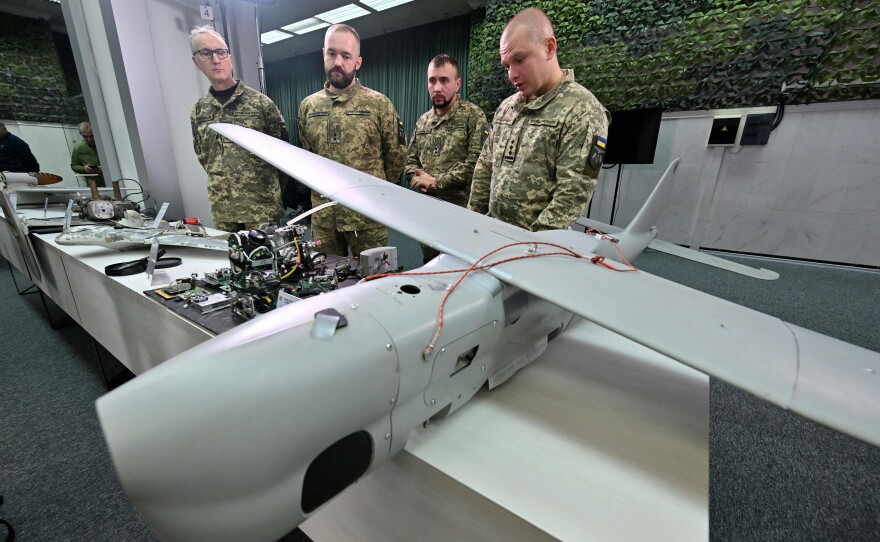 Ukrainian military personnel display a downed Russian drone during a press conference in the capital Kyiv on Dec. 15. Russia has been firing drones and missiles at Ukraine's power systems for the past four months.