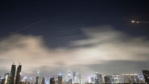 Israeli air defense system fires to intercept missiles during an Iranian attack over Tel Aviv, Israel, early Sunday, March 15, 2026.