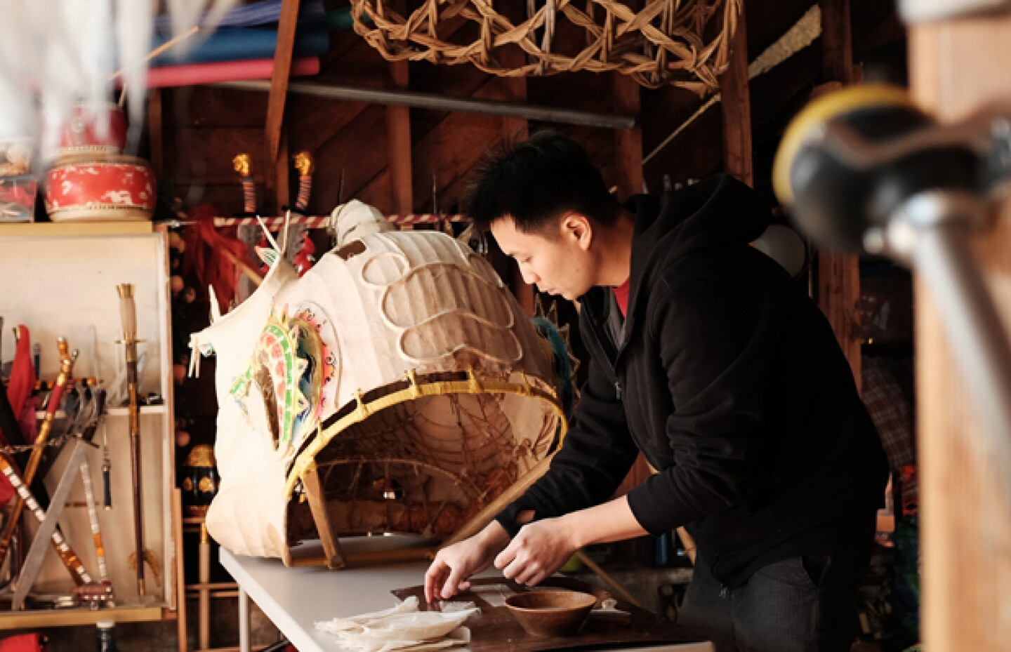 Travis Lum repairs a lion head for Chinese New Year celebrations.