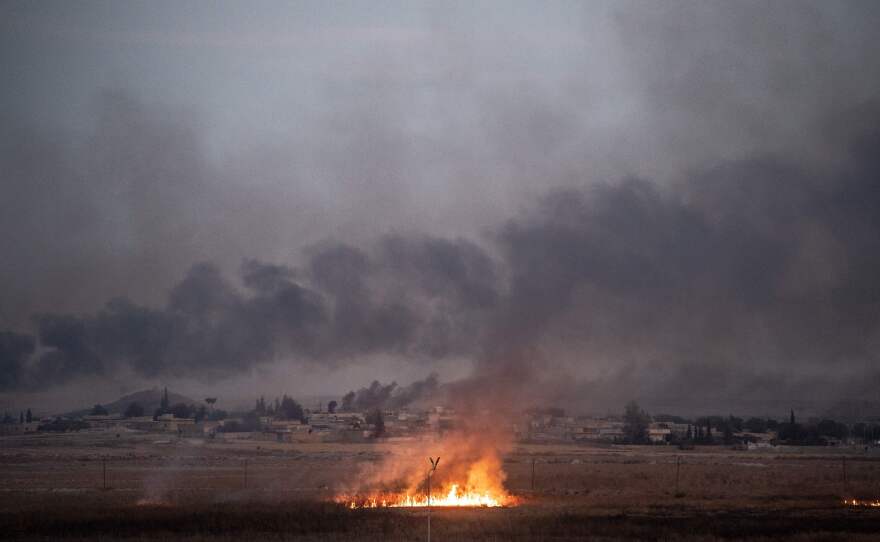 Smoke rises from the Syrian town of Tal Abyad on Thursday on the second day of Turkey's military operation against Kurdish forces. President Trump's decision to pull back U.S. forces from the area has been viewed as giving Turkey a green light for the operation and opened him up to condemnation from within the GOP.