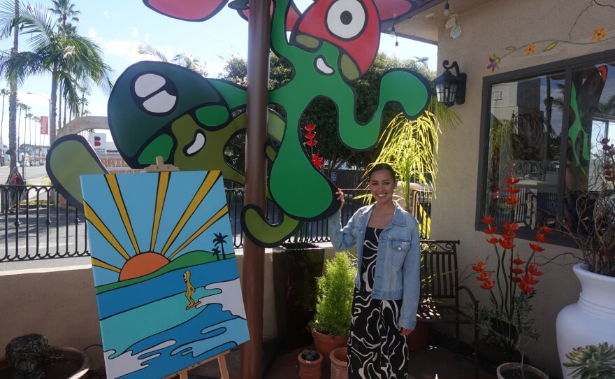 Bella Bowman with her art, "Bob the Blob" (left) and "Fun Guys" (right), in front of Carrillo Pottery in Oceanside on Jan. 26, 2026.