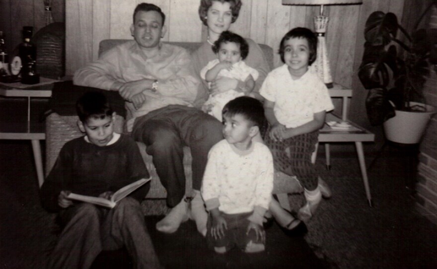 Young Nelson Figueras reading (bottom left) with Maltos family on sofa (Joe, Joey, Tina and Hope).