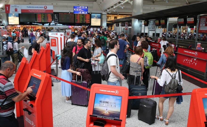 On Wednesday, passengers line up for flights as usual at Turkey's Ataturk airport.