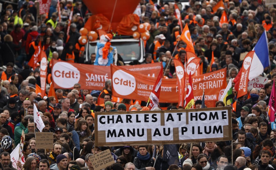 Workers demonstrate with a poster referring the King Charles III's canceled visit, on Tuesday in Nantes, western France.