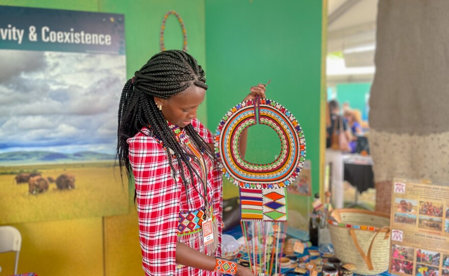 Simaloi Saitoti holds up a Maasai bead necklace given to women when they get engaged.