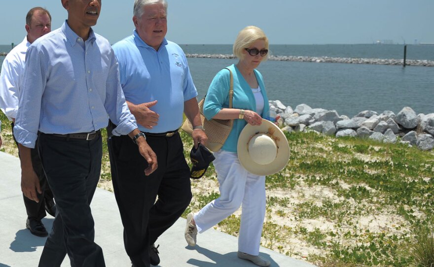 President Obama walks with Mississippi Gov. Haley Barbour and Barbour's wife, Marsha, in Gulfport on Monday.