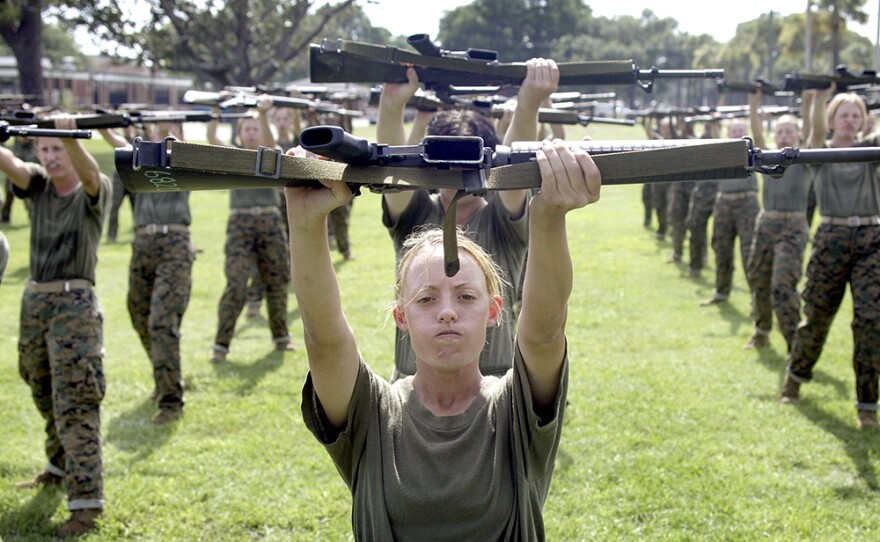 Female Marine Corps recruit Kylieanne Fortin, 20, of Williamsport, Maryland goes through close combat training at the United States Marine Corps recruit depot June 23, 2004 in Parris Island, S.C. Marine Corps boot camp, with its combination of strict discipline and exhaustive physical training, is considered the most rigorous of the armed forces recruit training. Congress is currently considering bills that could increase the size of the Marine Corps and the Army to help meet US military demands in Iraq and Afghanistan. Photo by Scott Olson/Getty Images