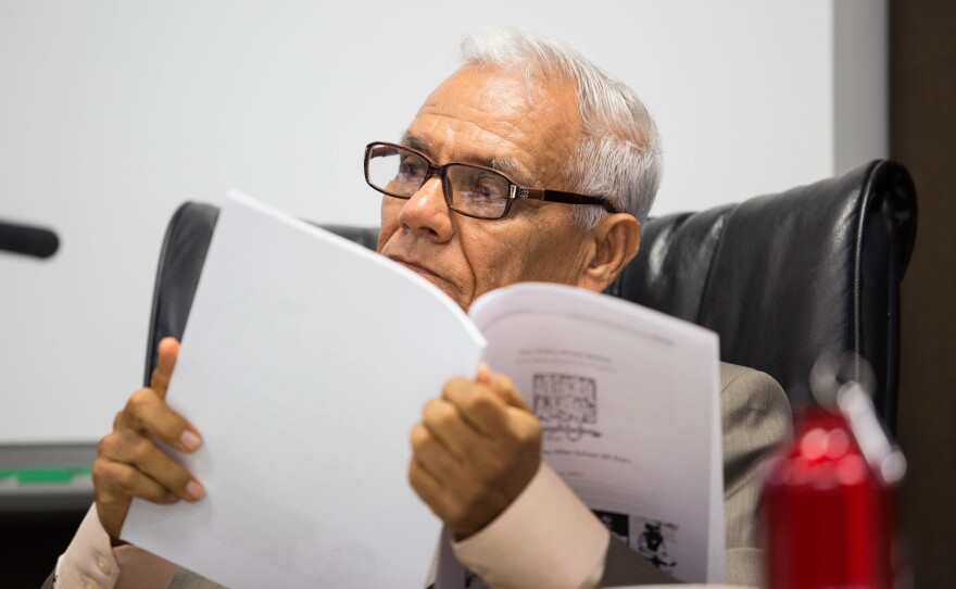Rodolfo Linares reads a document presented to the San Ysidro School District board, July 9, 2015. He was elected to the board in 2014.