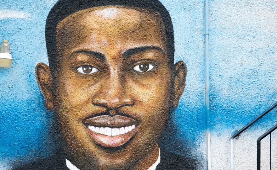 A mural depicting Ahmaud Arbery in July 2020 in Brunswick, Ga. Gregory McMichael, Travis McMichael, and William "Roddie" Bryan are facing murder charges in connection with his death.