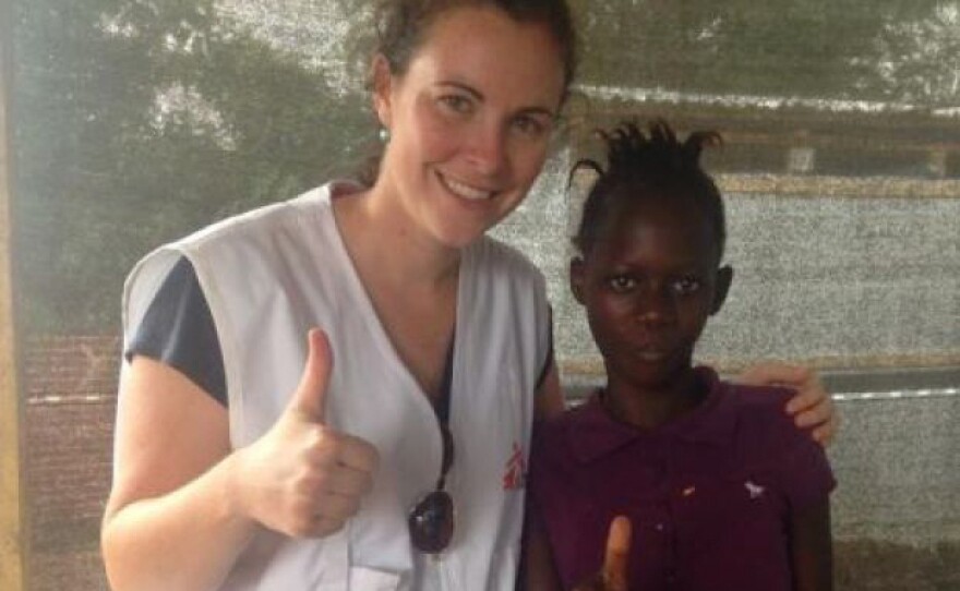 Health educator Emily Veltus shares a thumbs up with a 12-year-old who's an Ebola survivor. The girl was treated at the Doctors Without Borders center in Kailahun.