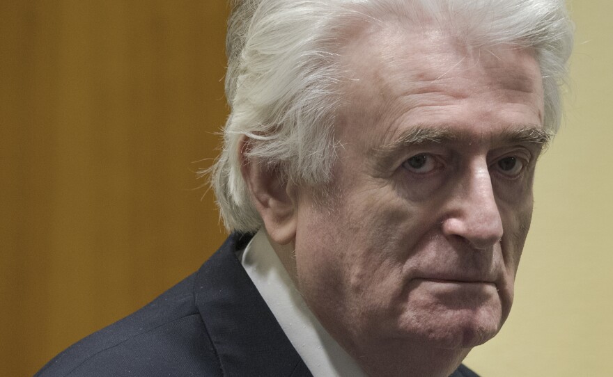 Former Bosnian Serb leader Radovan Karadzic enters the courtroom of the International Residual Mechanism for Criminal Tribunals in The Hague, Netherlands, on Wednesday.