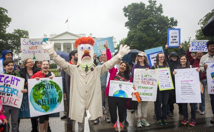 Members of the Union for Concerned Scientists pose for photos with Muppet character Beaker in front of The White House before heading to the National Mall for the March for Science.