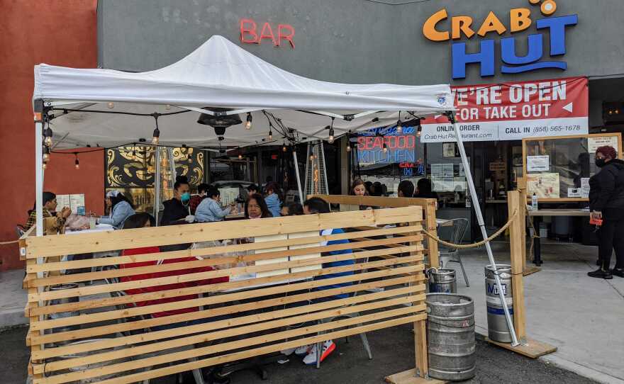 Customers seated outside in the parking lot at Crab Hut restaurant in Kearny Mesa, Feb. 15, 2021.