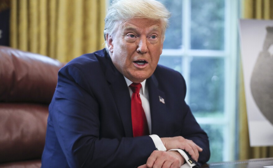 President Trump, pictured in the Oval Office on Thursday, maintains a lead over Democratic presidential nominee Joe Biden on the economy, but is behind on handling of the coronavirus pandemic in a new NPR/<em>PBS NewsHour/</em>Marist poll.