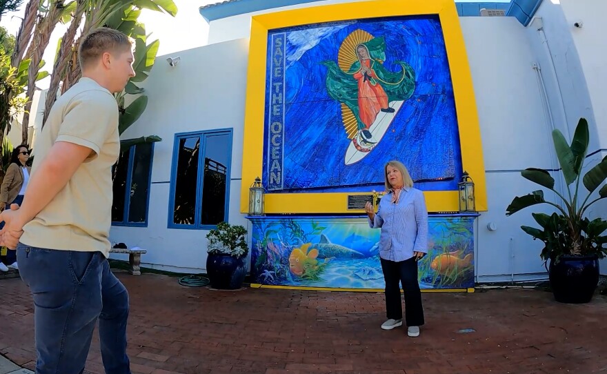 Naimeh Woodward stands in front of the Surfing Madonna mosaic, Oct. 4, 2023.