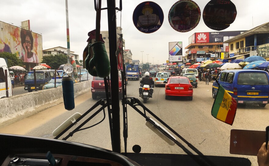 The tro tros are the ubiquitous vans that serve as group taxis in Accra. Their windshields are adorned with affirmative, often-religious sayings like, "God Is The Way."