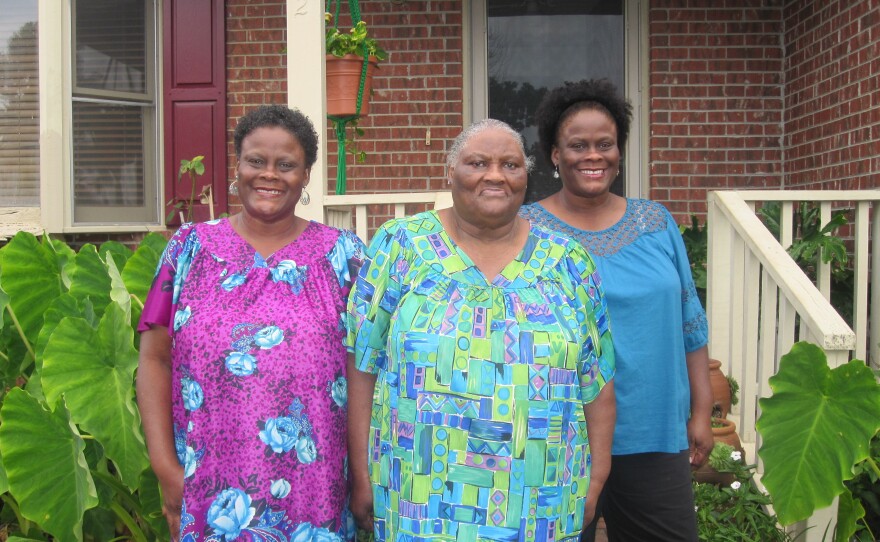 Alberta Currie, 78, is flanked by her twin daughters, Brenda Bethea (left) and Linda Blue, outside their house in Hope Mills, N.C. Currie says she has voted at polling places since 1956, despite literacy tests and daylong waits in the days before the Voting Rights Act. Under North Carolina's new voter ID law, Currie will have to vote absentee if at all, because she can't get a state photo ID.