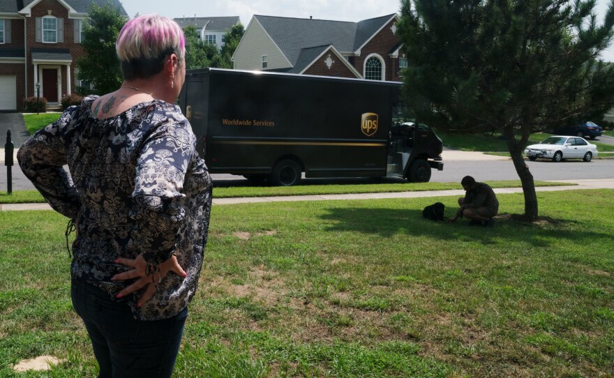 A UPS driver visits with Lizzy outside of Michel's home, something Michel says he does every time he drives through the neighborhood.