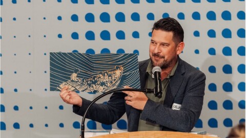 Author photo of person on podium giving a speech