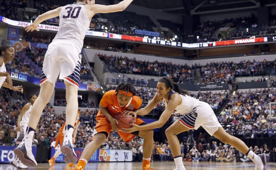 Syracuse's Cornelia Fondren, (center) and Connecticut's Napheesa Collier (right) battle for a loose ball as UConn's Breanna Stewart goes airborne, preparing to block a shot in the first half of the NCAA championship game.