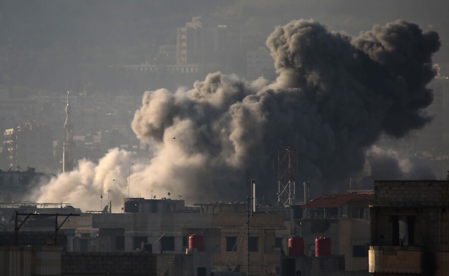 Smoke billows into the sky above eastern Ghouta after a wave of airstrikes Monday. Over the past month, the region of nearly 400,000 has seen its deadliest spasm of violence in years.