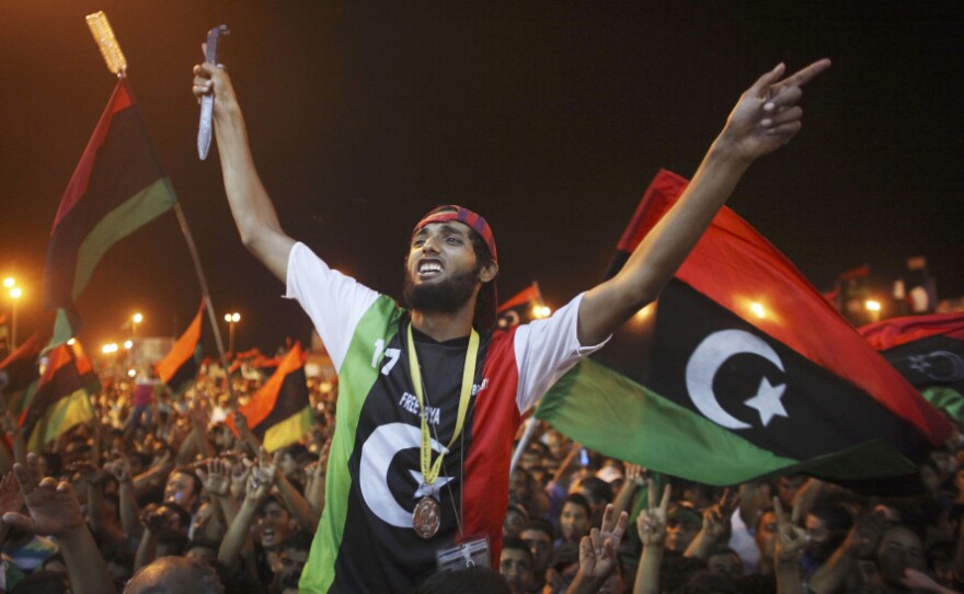 People celebrate the capture in Tripoli of Moammar Gadhafi's son and one-time heir apparent, Seif al-Islam, at the rebel-held town of Benghazi, Libya, early Monday. Libyan rebels raced into Tripoli in a lightning advance Sunday that met little resistance as Gadhafi's defenders melted away and his 42-year rule appeared to rapidly crumble.