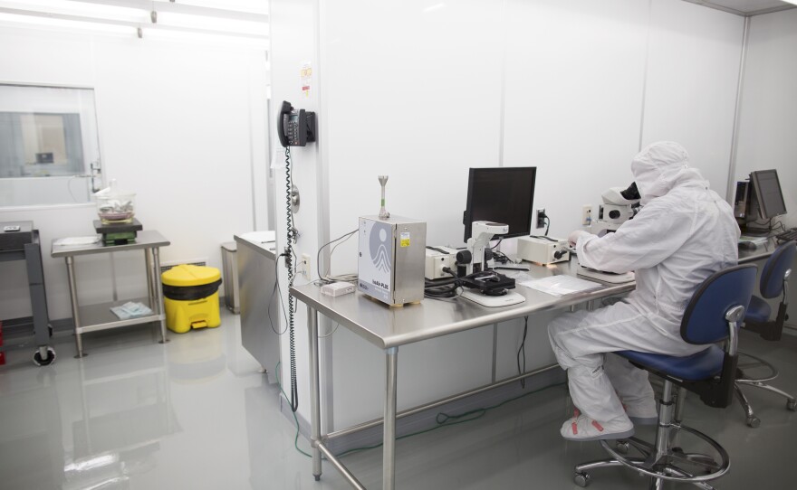 An employee works in a clean room at Exelis. Mike Ognenovski, the company's vice president of operations, says he wants to make the work here "more of a science versus an art."