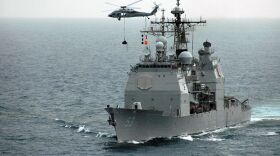 An MH-60S Seahawk assigned to Helicopter Sea Combat Squadron (HSC) 23 delivers supplies to the Ticonderoga-class guided-missile cruiser USS Mobile Bay.
