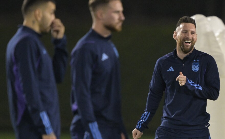 Argentina forward Lionel Messi (R) laughs during a training session at Qatar University in Doha on Dec. 12, 2022, a day before the Argentina's World Cup semifinal match against Croatia.