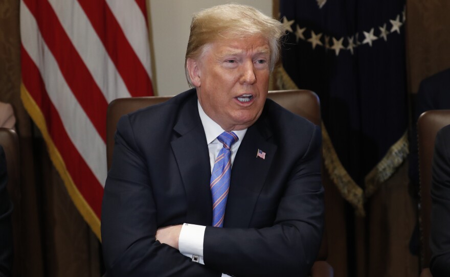 Asked by reporters at the start of a Cabinet meeting whether Russia is still targeting the U.S., President Trump shook his head and said "no."
