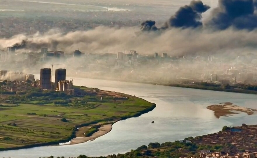This video grab taken from AFPTV video footage on April 19 shows an aerial view of black smoke covering the sky above the capital Khartoum.