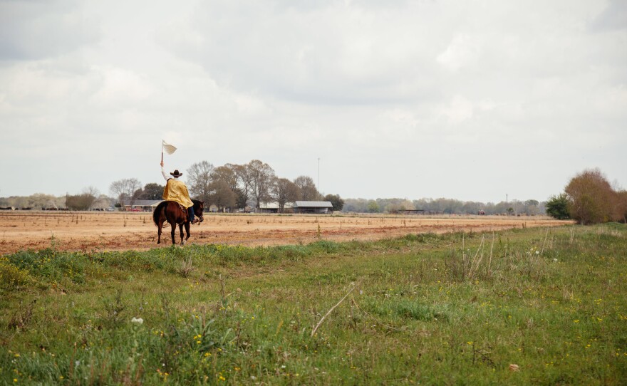<em>Le Capitaine</em> signals the Mardi Gras to follow back to the start of the courir where gumbo will be eaten, music will be played.