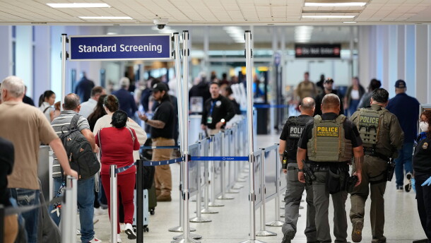 Federal immigration officers walk through a security checkpoint at George Bush Intercontinental Airport in Houston in March.